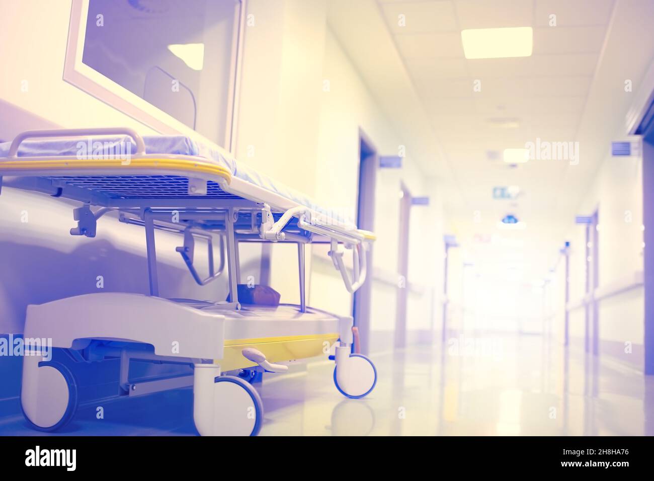 Stretcher in the empty hospital corridor ending with a flash of light. Stock Photo