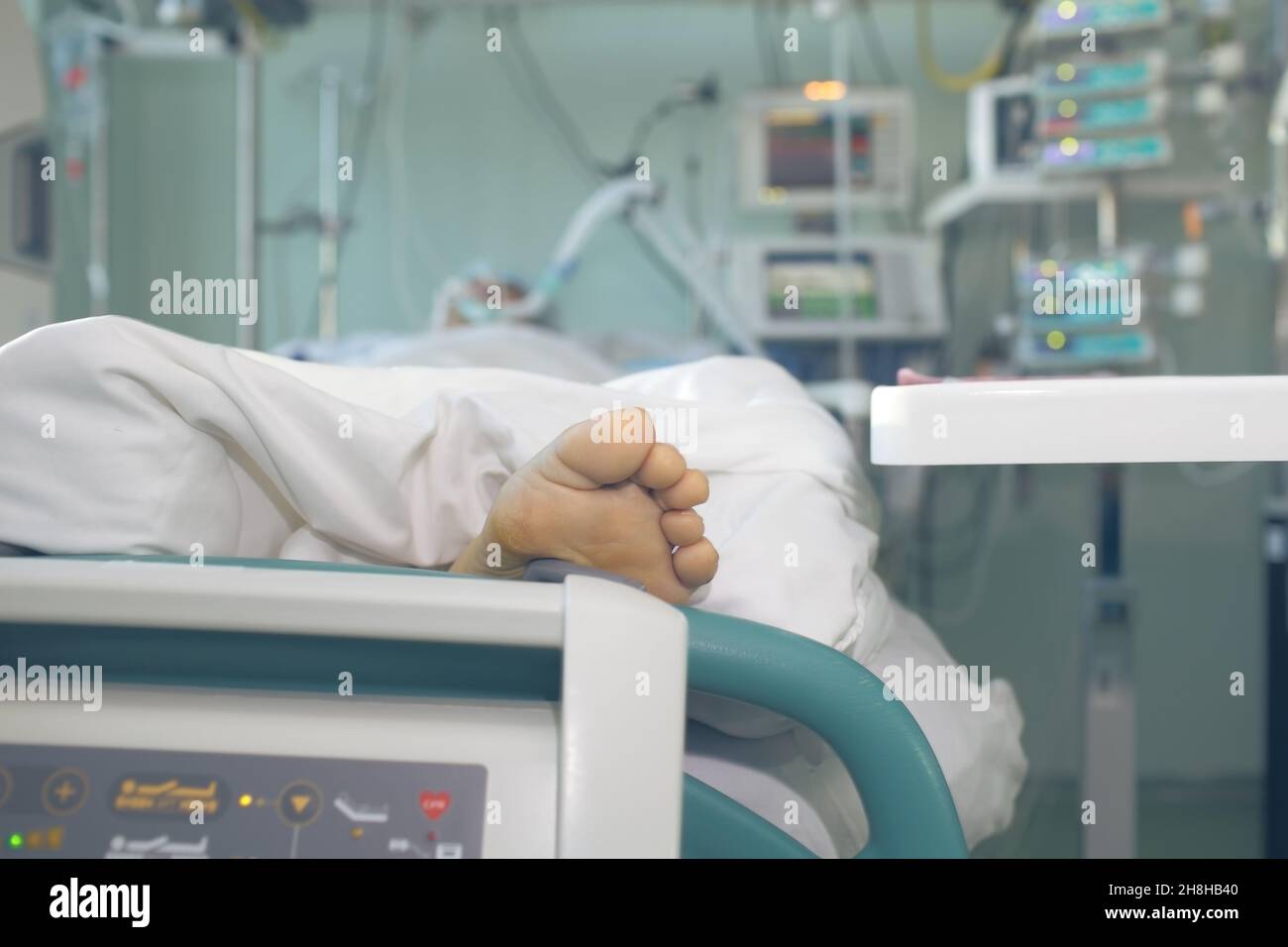 Patient in serious condition connected to the life support devices. Stock Photo