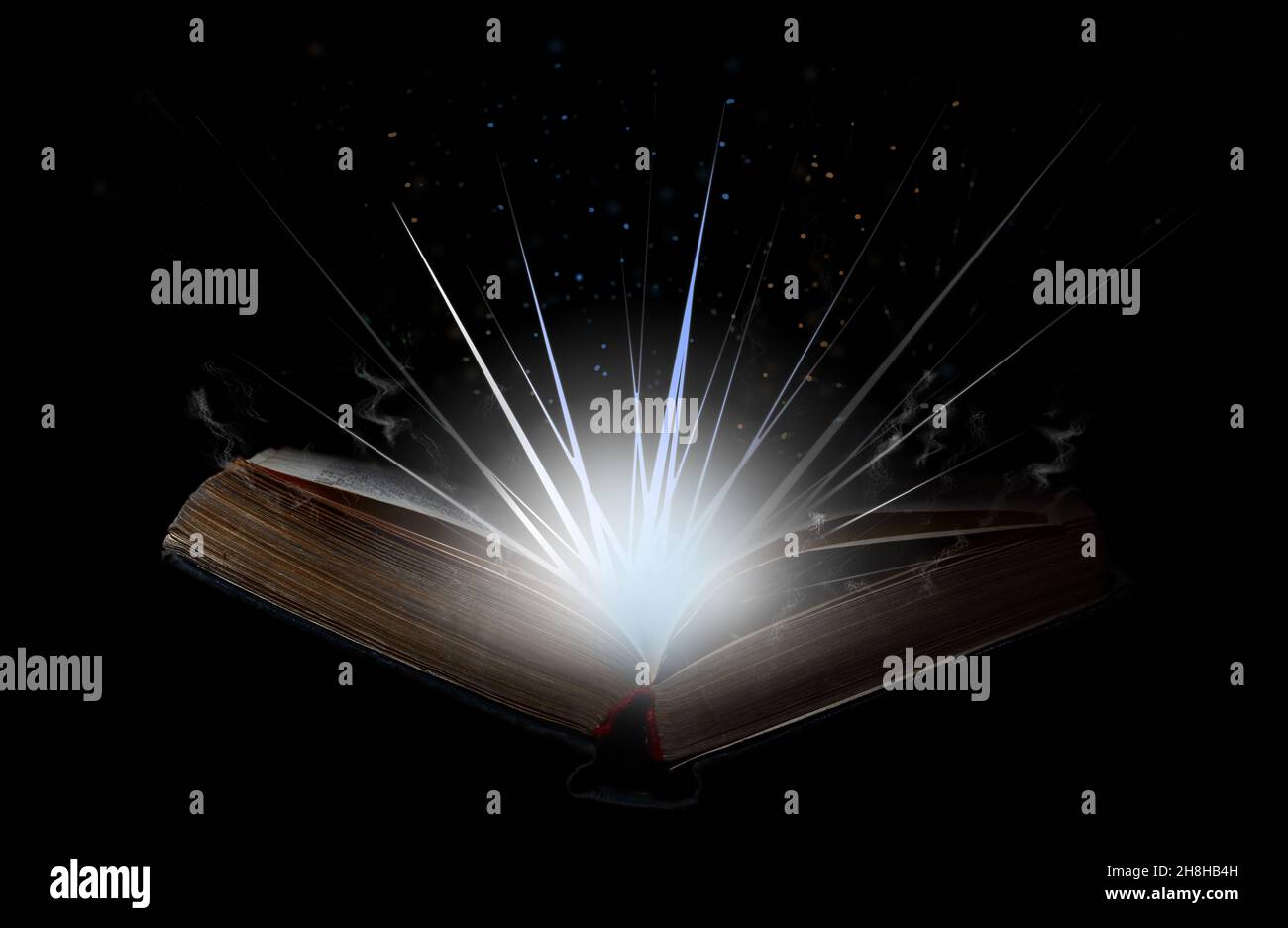 Open book with flash of light, magical smoke and glitter in the air. Stock Photo