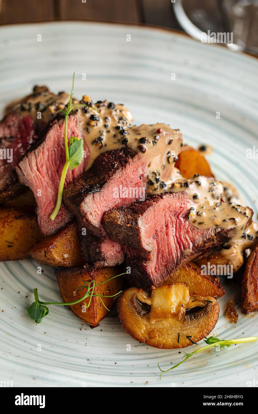 Beef medallions dish with potatoes and mushrooms Stock Photo