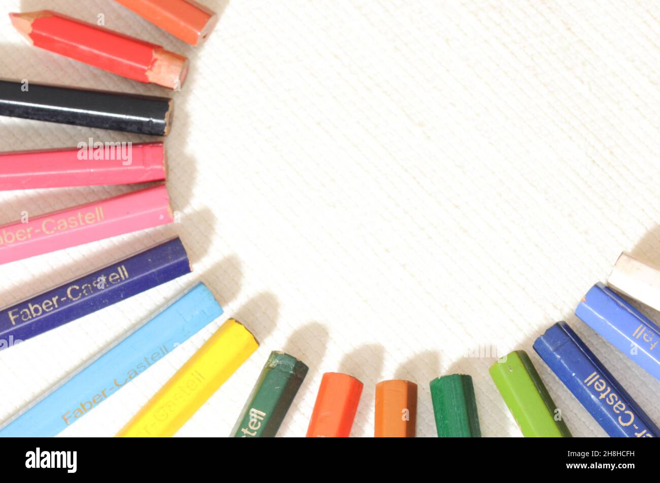 Colorful and funny arrangement of a set of pencils and ink pots Stock Photo