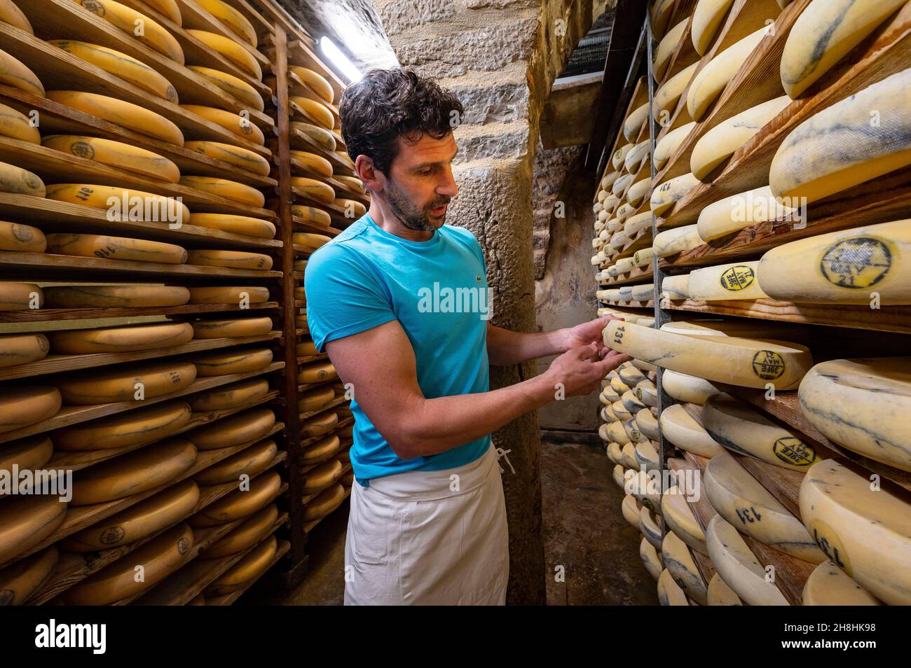 France Jura Chateau Chalon Granges Sur Baume Hauteroche La Fromagerie Poulet Herve Poulet Returns These Morbier Cheeses To Their Magnificent Vaulted Maturing Cellar Stock Photo Alamy