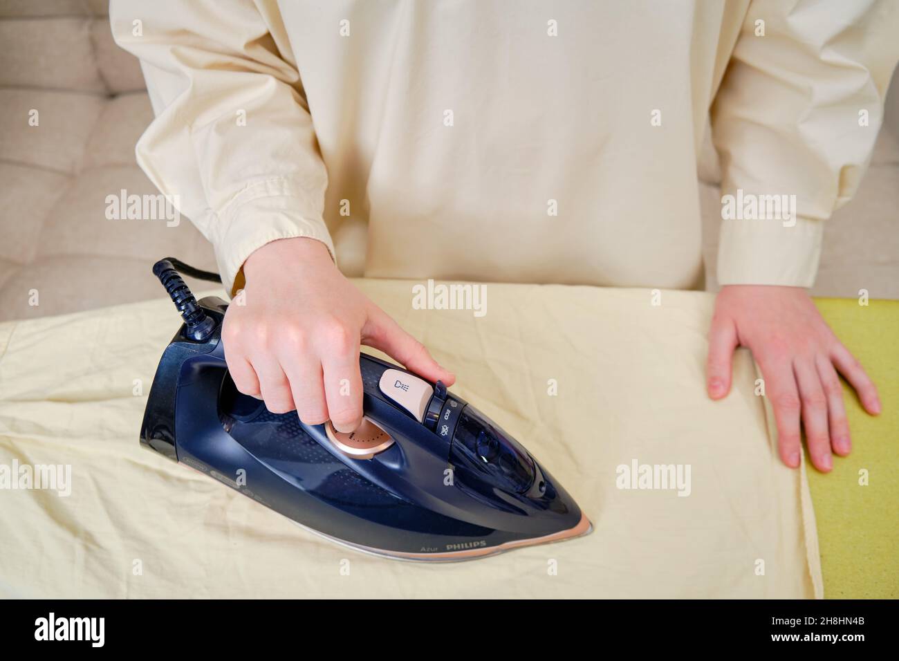 Close-up Of Woman's Hand Ironing Cloth On Ironing Board Stock Photo - Alamy