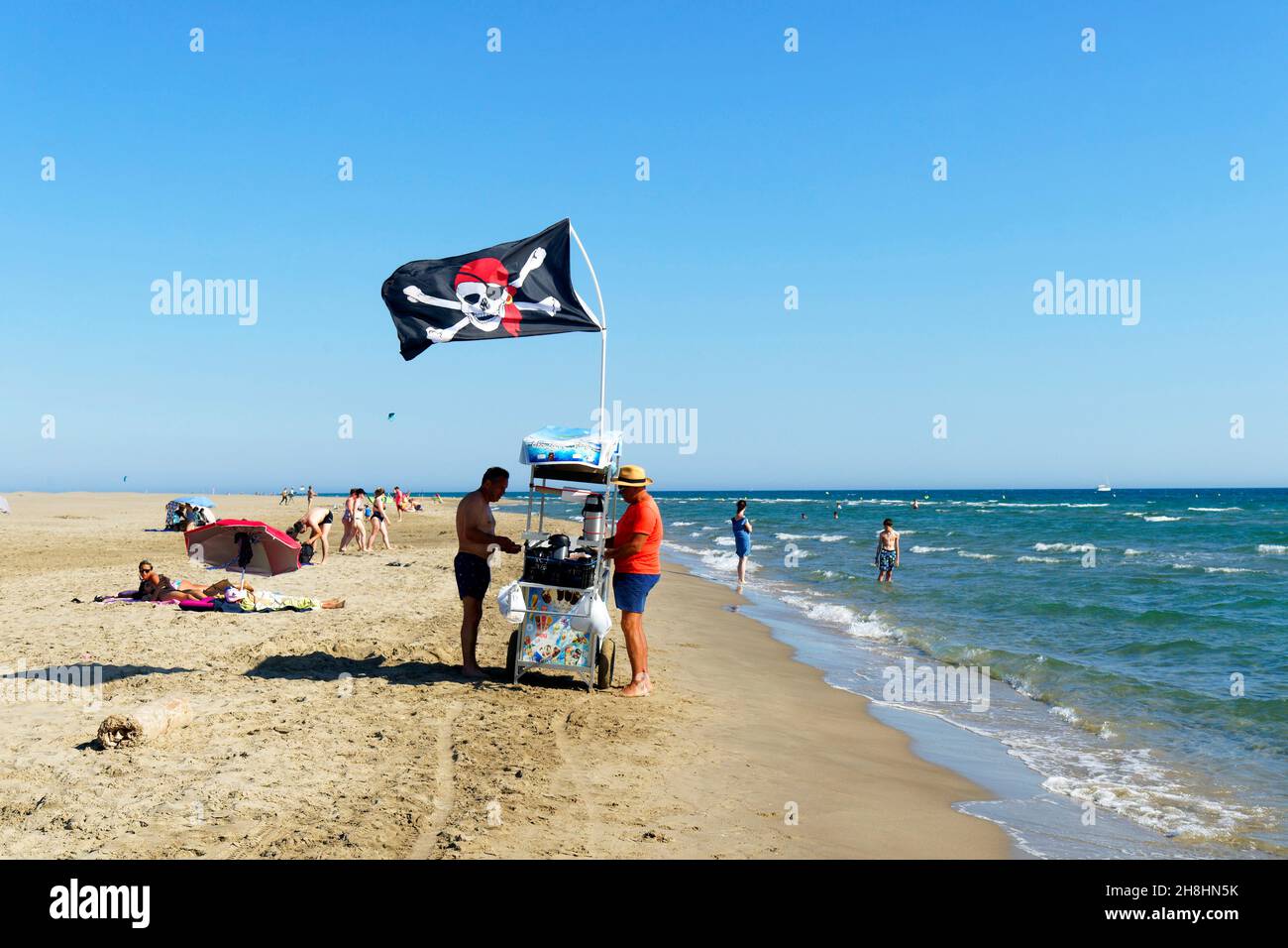 France, Gard, Camargue, Le Grau du Roi, walking beach salesman on Espiguette beach, the conservation area of the dunes of Espiguette Stock Photo