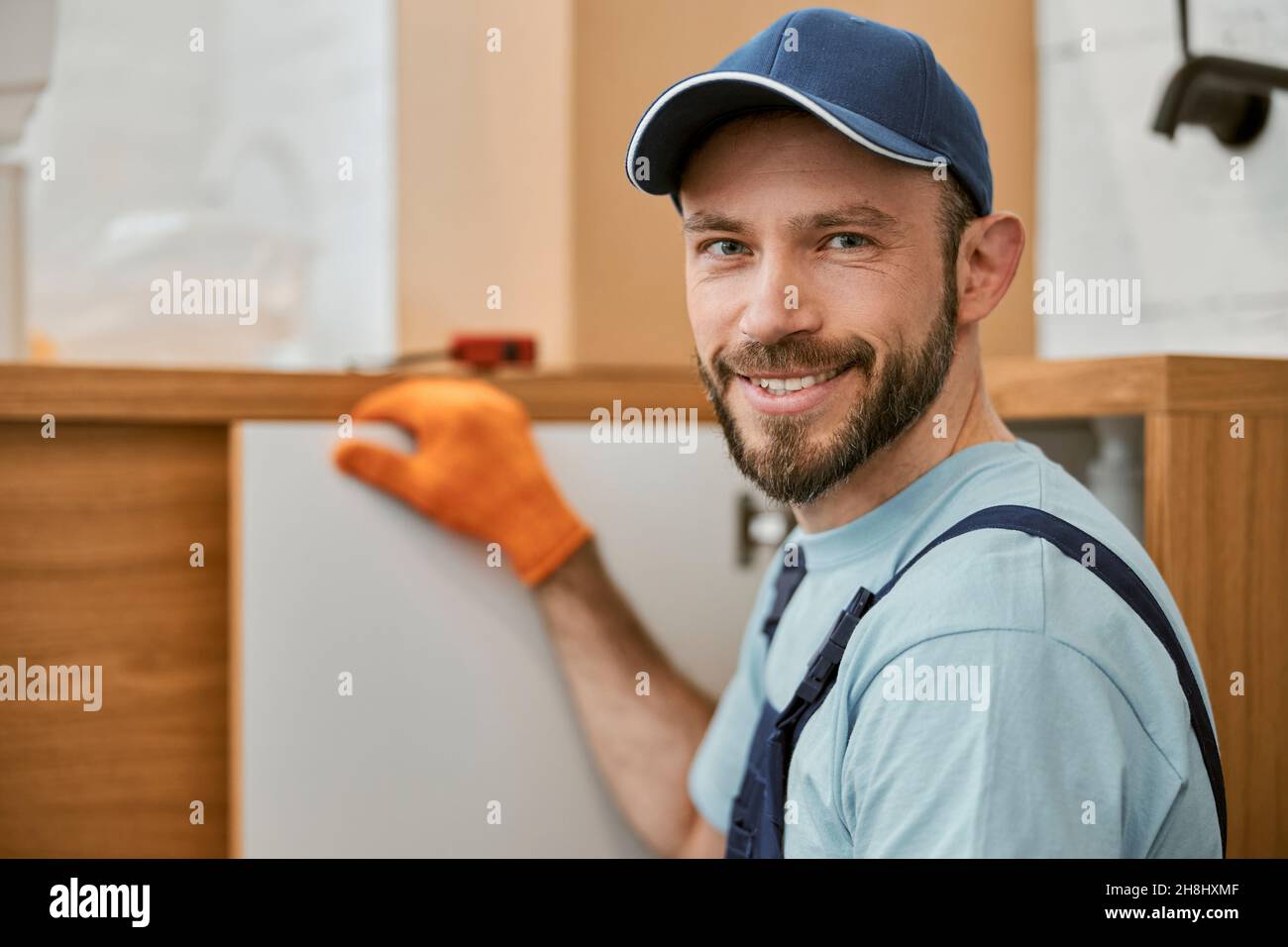 Joyful male worker looking at camera and smiling Stock Photo