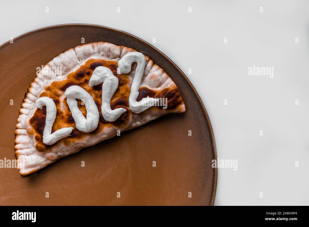 The number 2022 is written on a cheburek. New year 2022 is coming soon. Stock Photo