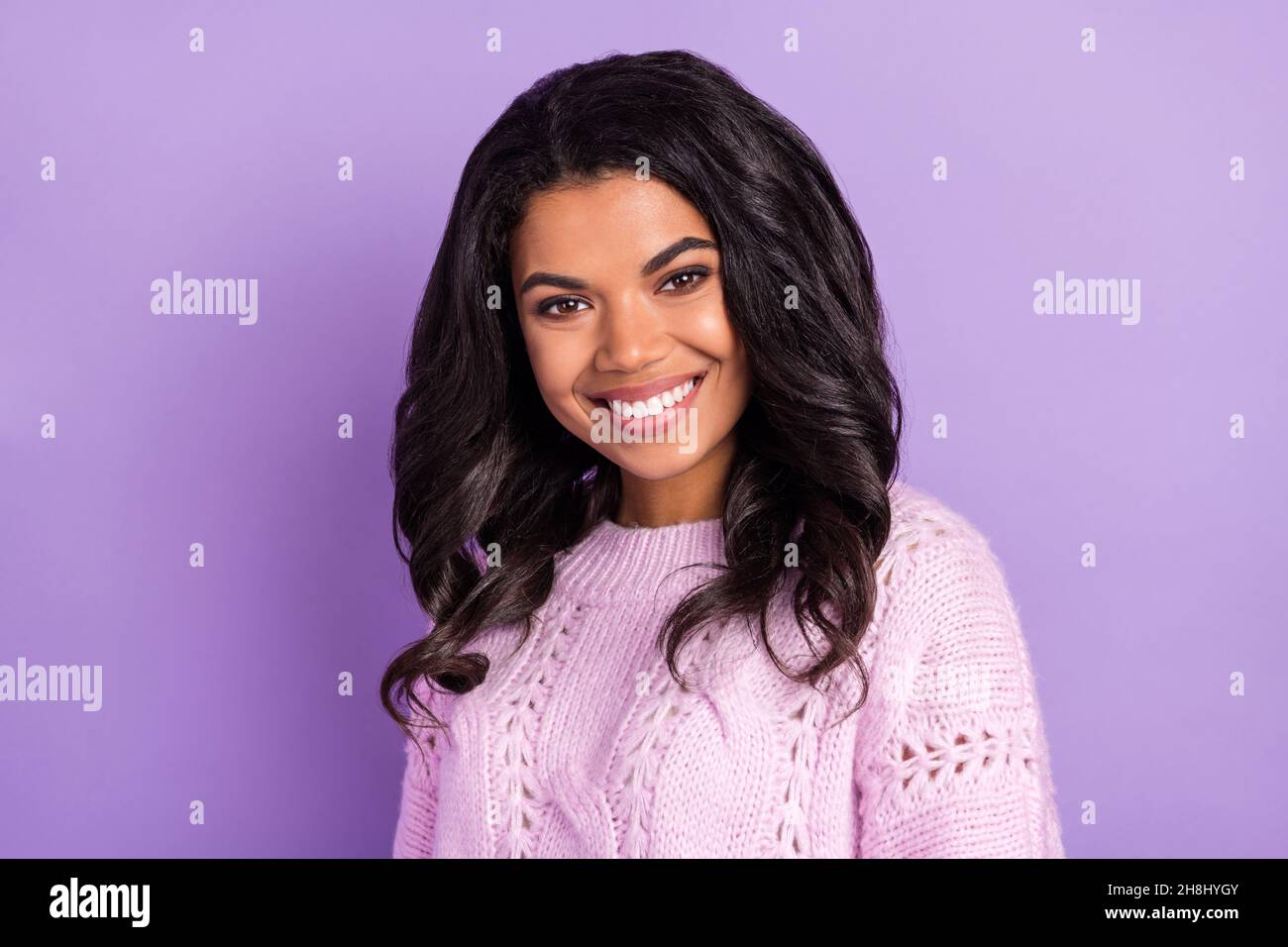 Photo of sweet adorable dark skin lady dressed knitted pullover smiling isolated purple color background Stock Photo