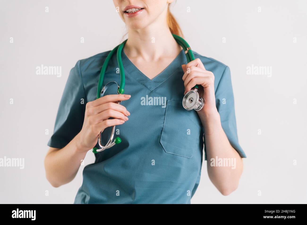Close-up cropped shot of unrecognizable female doctor in green medical ...
