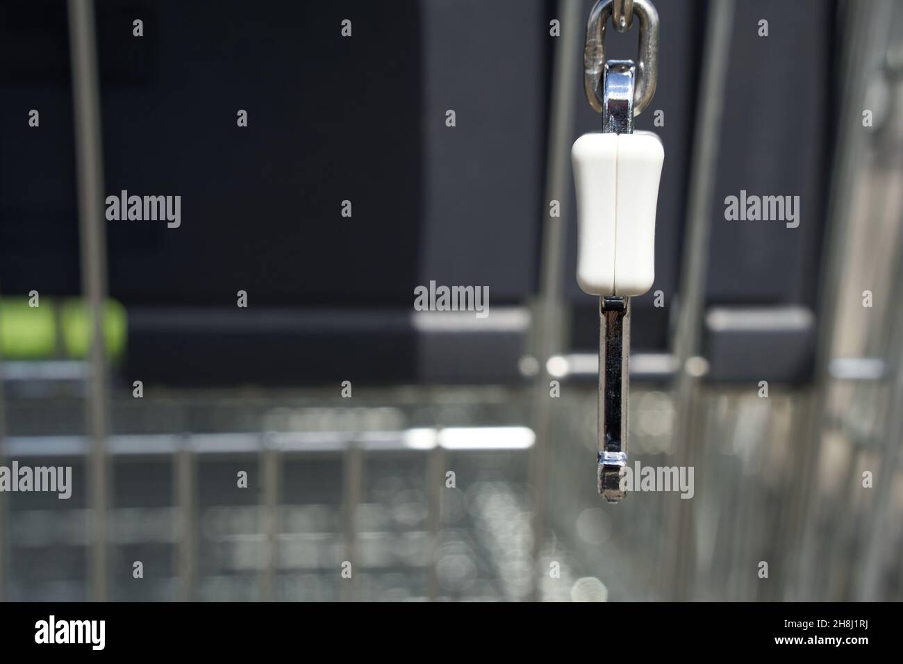 Latch of a deposit lock of shopping carts. Security device against theft of push carts. Closeup. Stock Photo