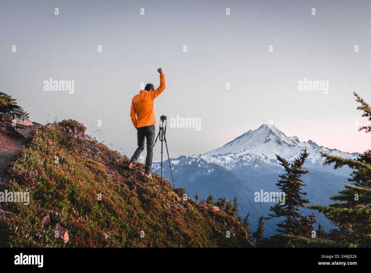 A man with a camera is taking pictures of mt. Baker Stock Photo