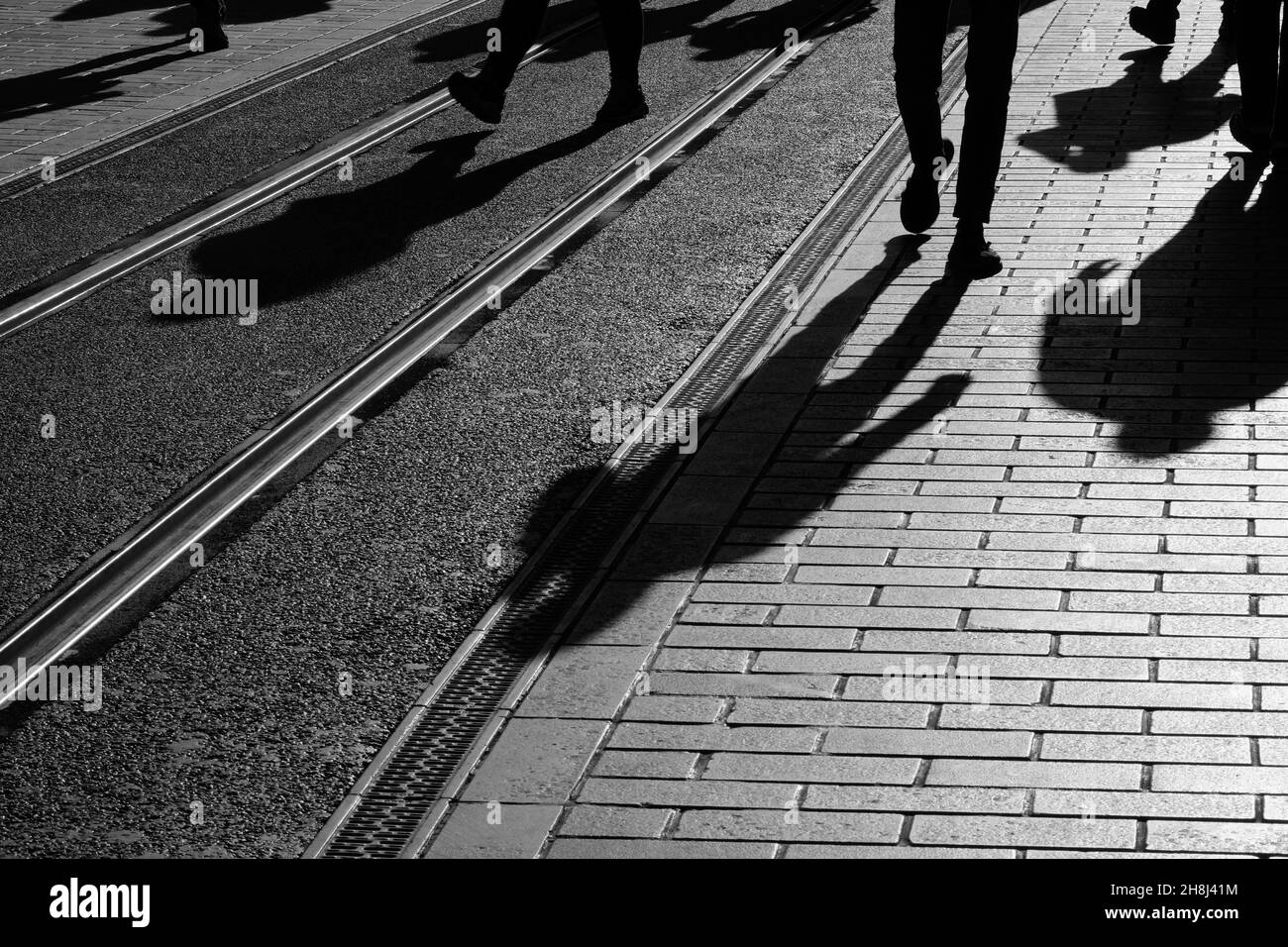 Shadows of people at Beyoglu, Istanbul, Turkey. There are tram rails on the ground. Stock Photo
