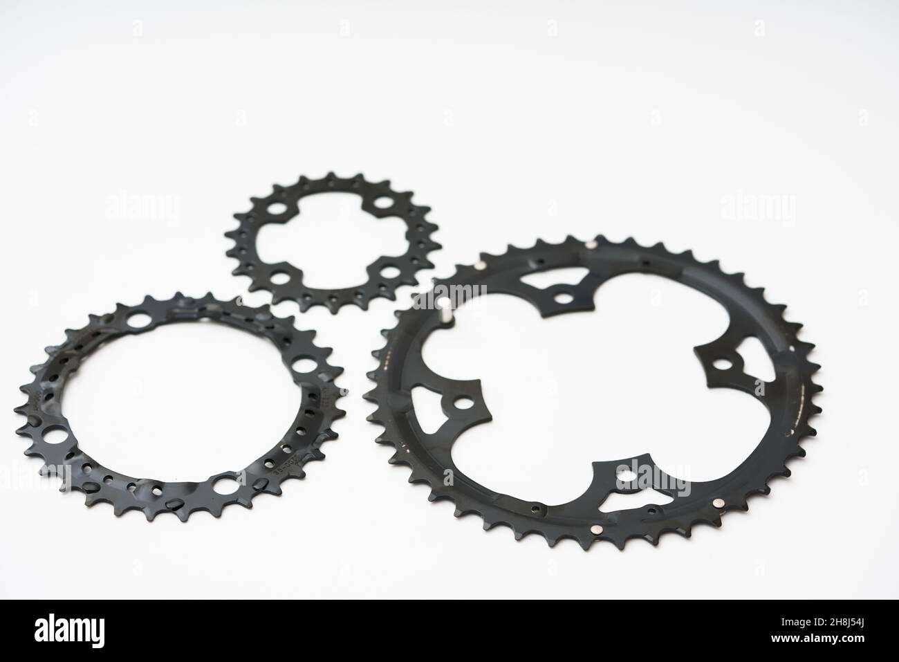 Gears, sprockets and chain of a mountain sports bike on a white