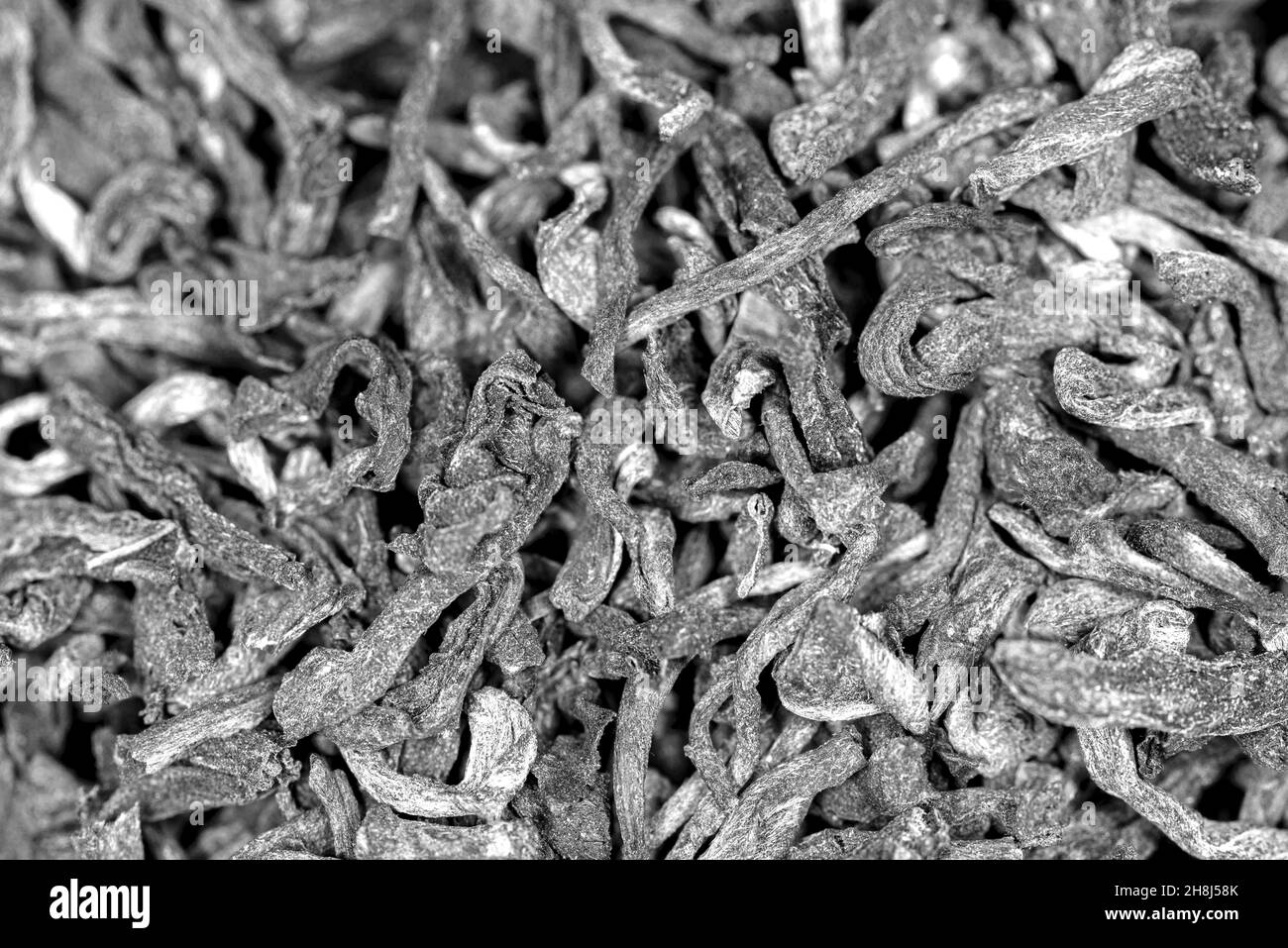 Chinese bulk extruded tea ripe puer, macro, black and white photo Stock Photo