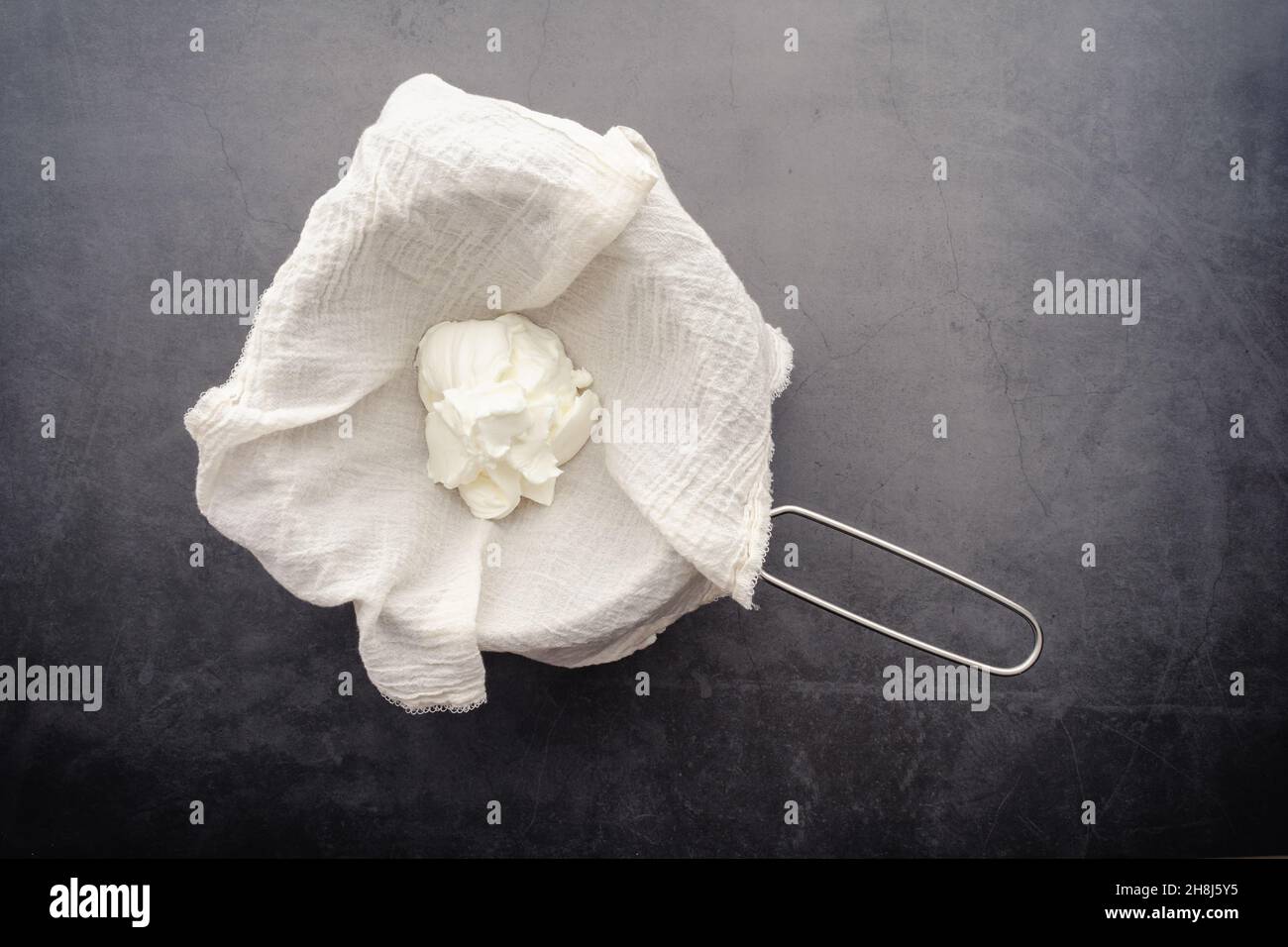 Making Labneh Cheese in a Cheesecloth Lined Strainer Straining yogurt