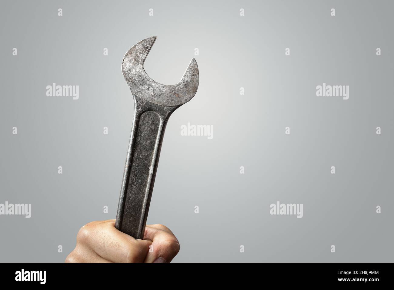 Large wrench tool held by a hand Stock Photo