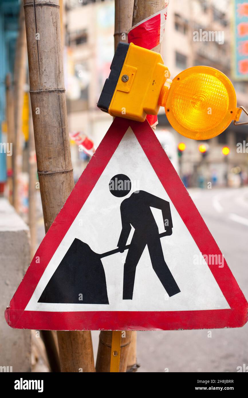 Men at work warning in a construction site in Hong Kong, China Stock Photo