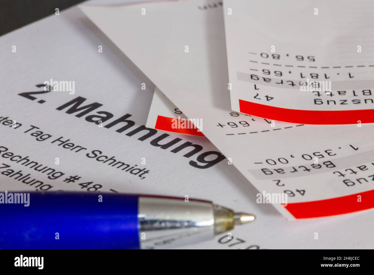 Symbolic image of debt, over-indebtedness: Close-up of bank statements and a dunning notice Stock Photo
