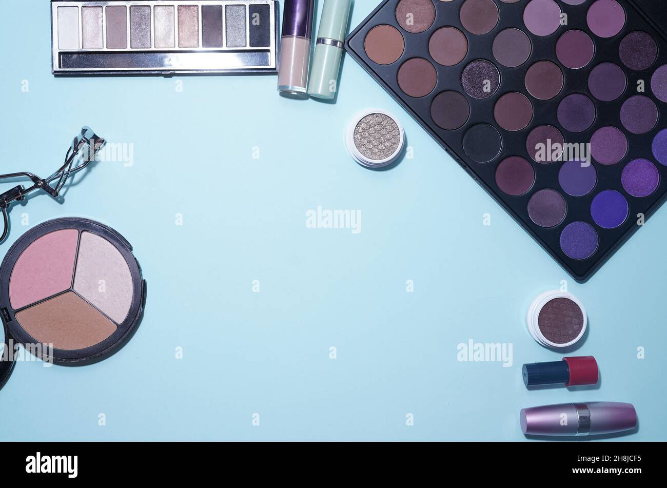 Decorative cosmetics on a blue background, top view. Make-up with professional cosmetics. A flat image with space to copy. High quality photo Stock Photo