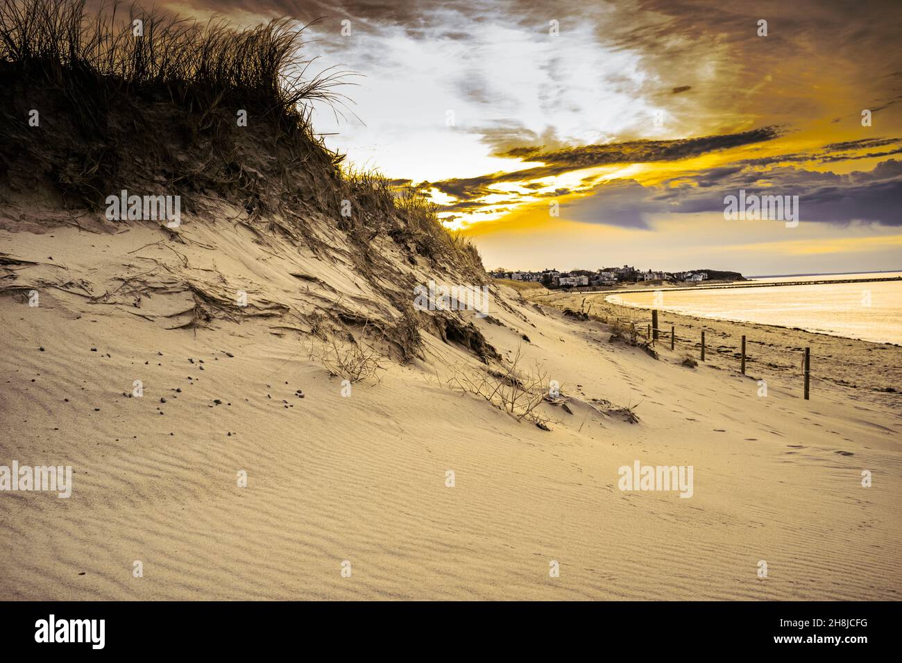 Nature created these beautiful, dramatic storm clouds.  However, the upcoming storm is going to cause additional erosion to the sand dunes. Stock Photo