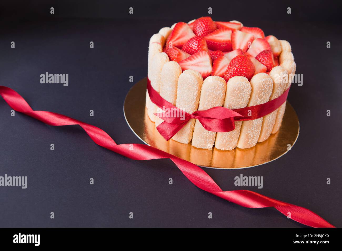 tiramisu cake with strawberries, ladyfingers, mascarpone and red bow