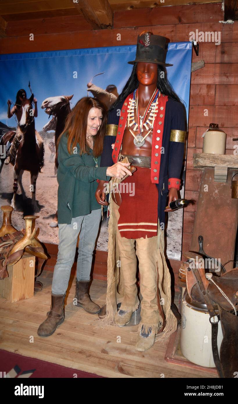 Cathy Smith poses with reproduction Native American clothing and regalia she makes for period Western movies and television series. Stock Photo