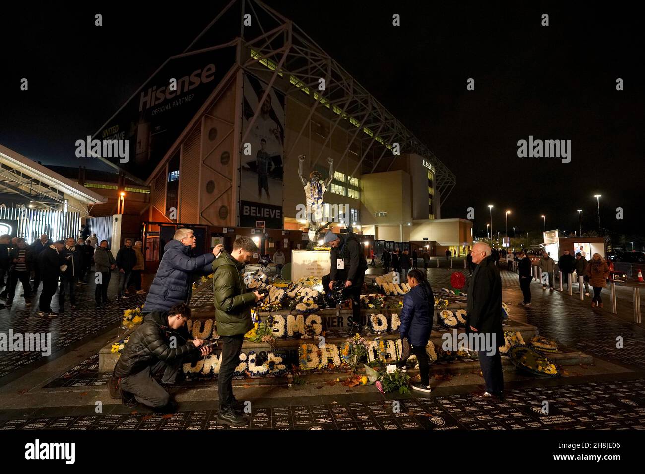 Former Leeds United player Eddie Grey and Sukai Martin help film a
