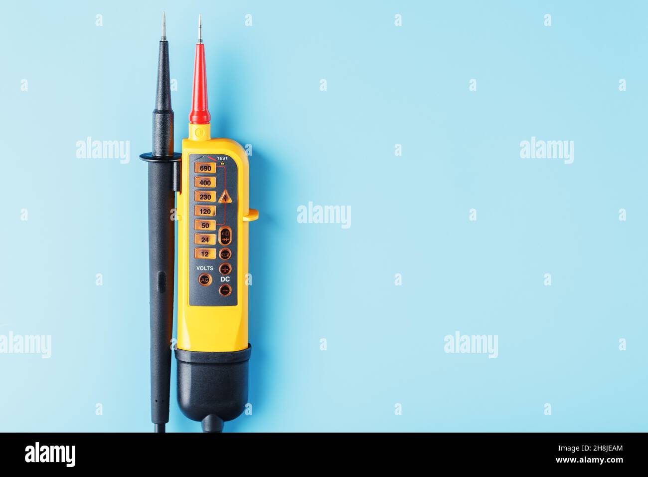 Two-pole voltage indicator close-up on a blue background. Testing and verification of electrical networks Stock Photo