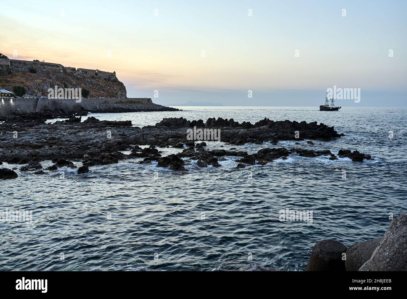 Sailing ship against the walls of the Venetian fortress in the city of Rethymno on the island of Crete in Greece Stock Photo