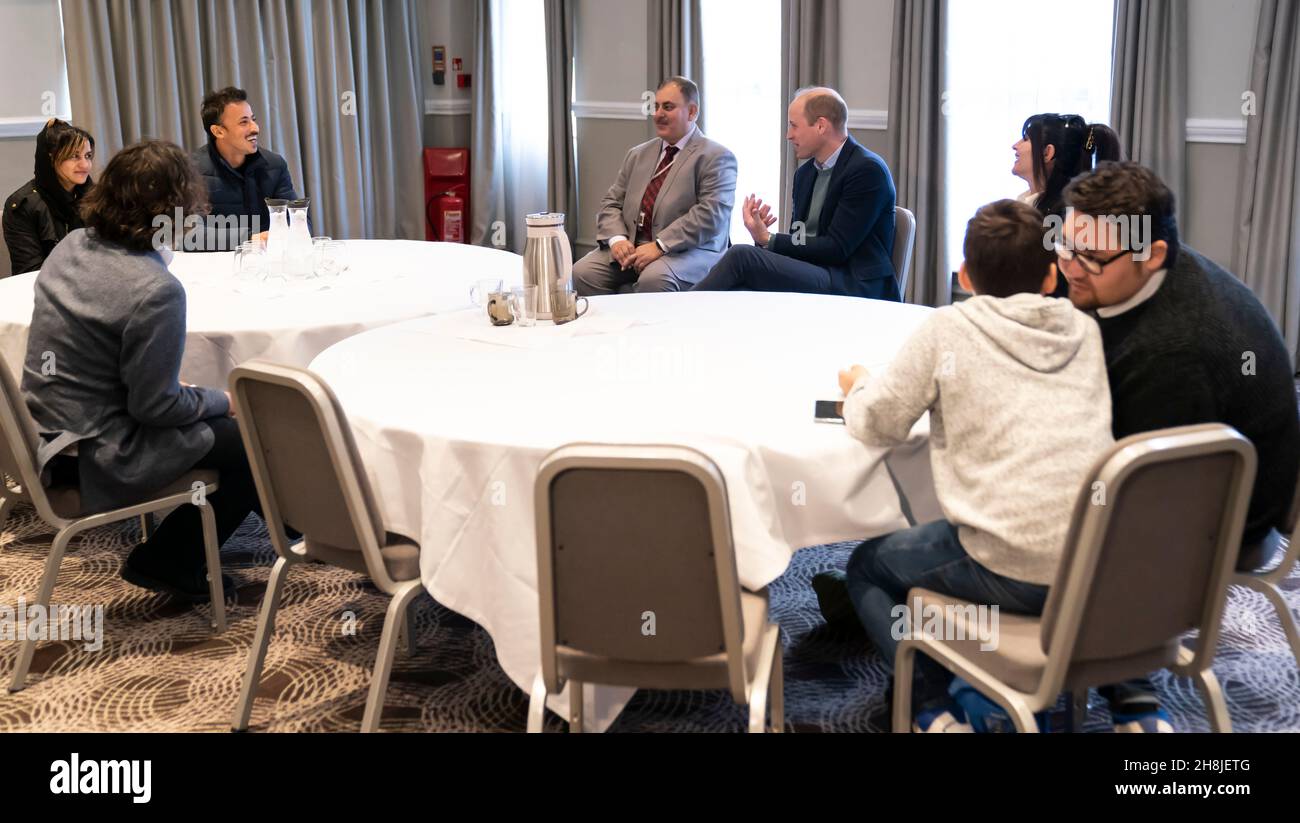 Duke of Cambridge meets refugee including Haroom Shahab (back second left) and Hussain Saeedi Samangan(right) during his visit to a hotel in Leeds, which is being used to accommodate refugees evacuated from Afghanistan. Picture date: Tuesday November 30, 2021. Stock Photo