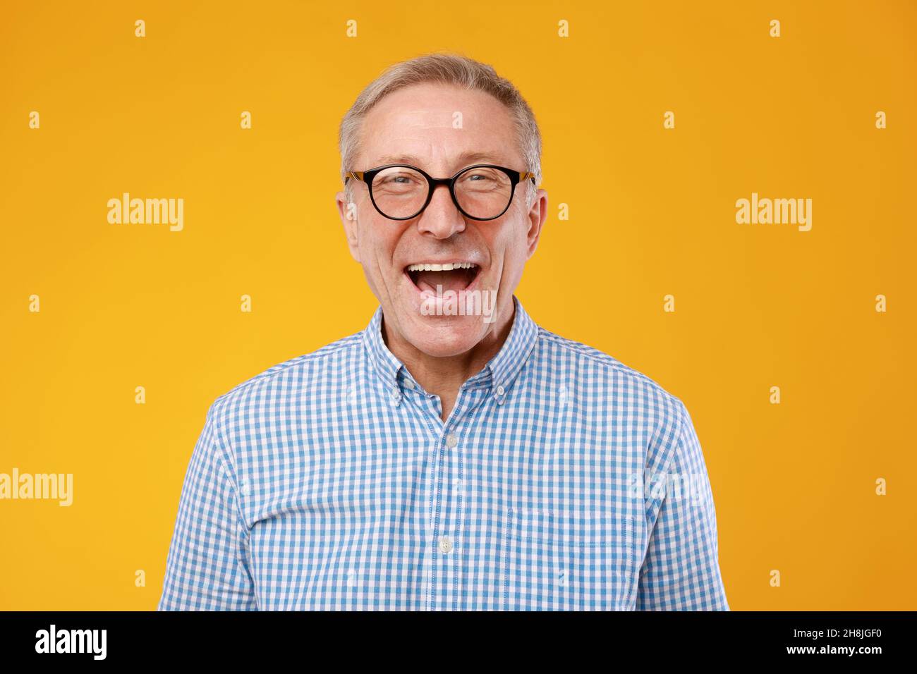 Portrait of happy mature man in glasses posing at studio Stock Photo