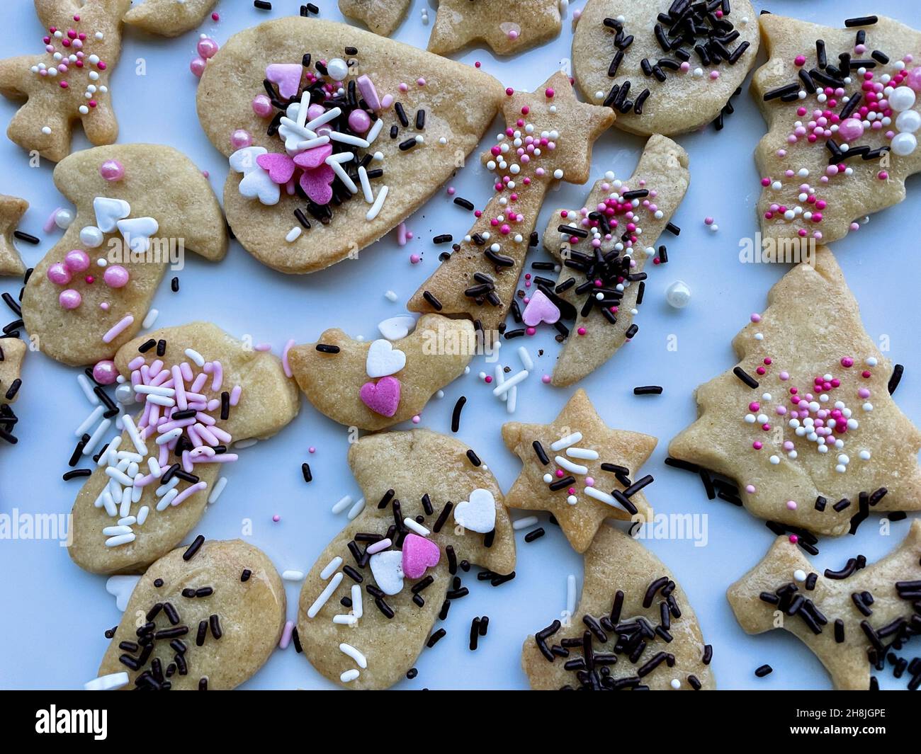 Colorful traditional Christmas cookies made by children. Christmas family baking concept. Aerial view. Stock Photo