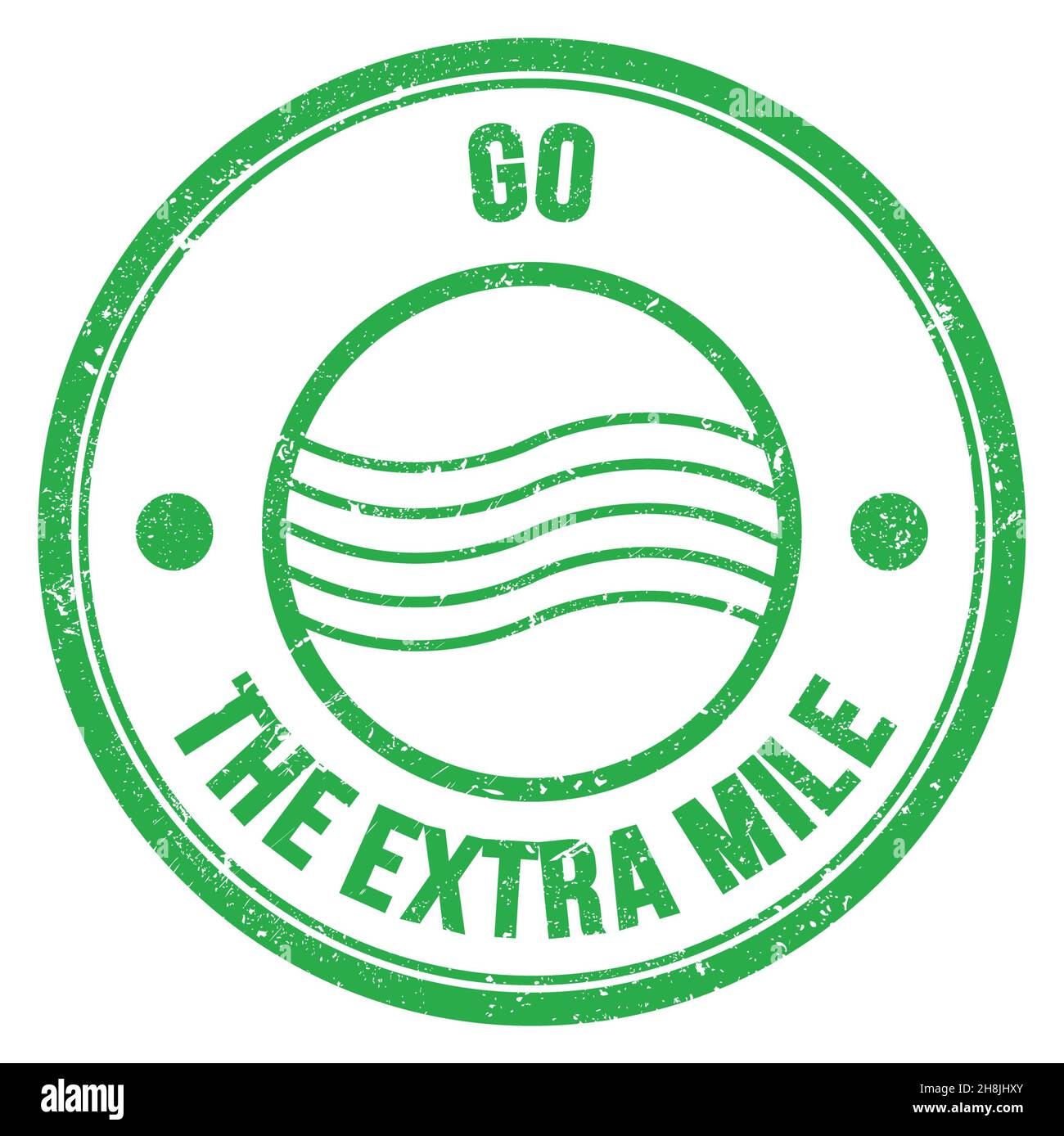 GO THE EXTRA MILE text written on green round postal stamp sign Stock