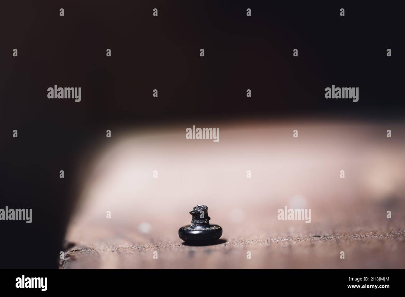 bolt head turned over to show sheared threading after stress failure