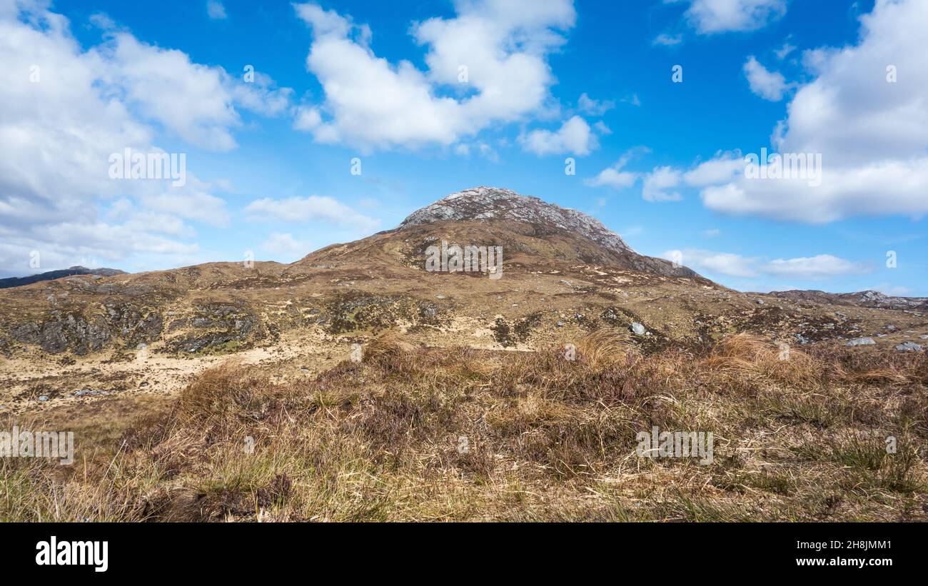 View of Diamond Hill in Connemara National Park, County Galway in the west of Ireland with blue sky and white fluffy clouds. Stock Photo