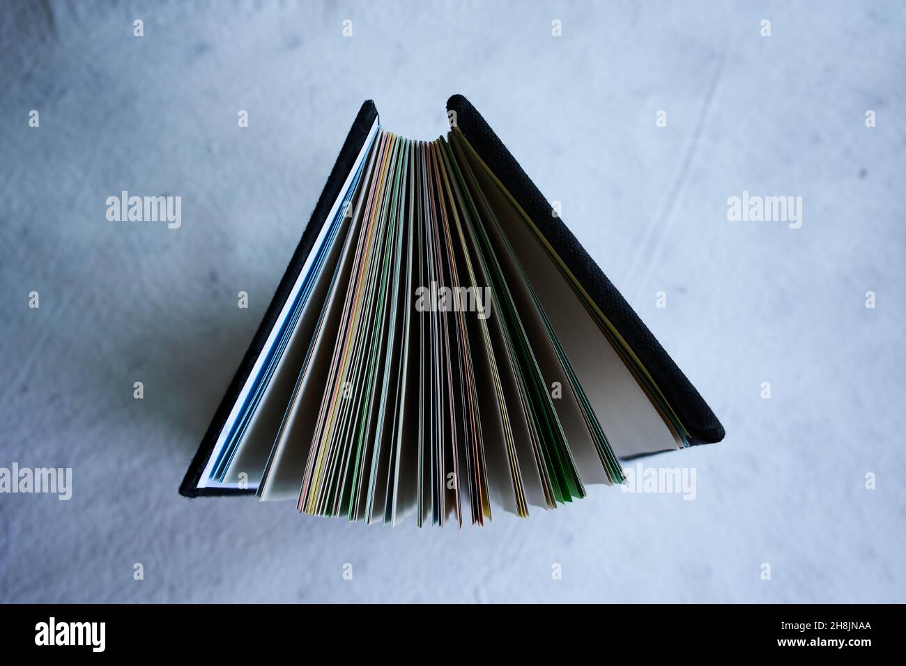 Top view of a folder portfolio with colorful paper sheets isolated on a white background Stock Photo