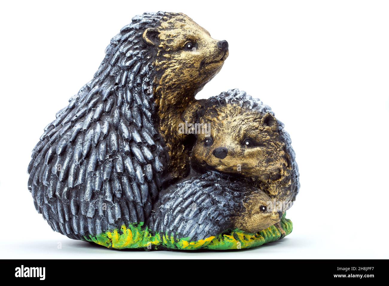 family of hedgehogs concrete garden sculpture for landscaping and backyard decoration, isolated stone object painted with paint on a white background, Stock Photo