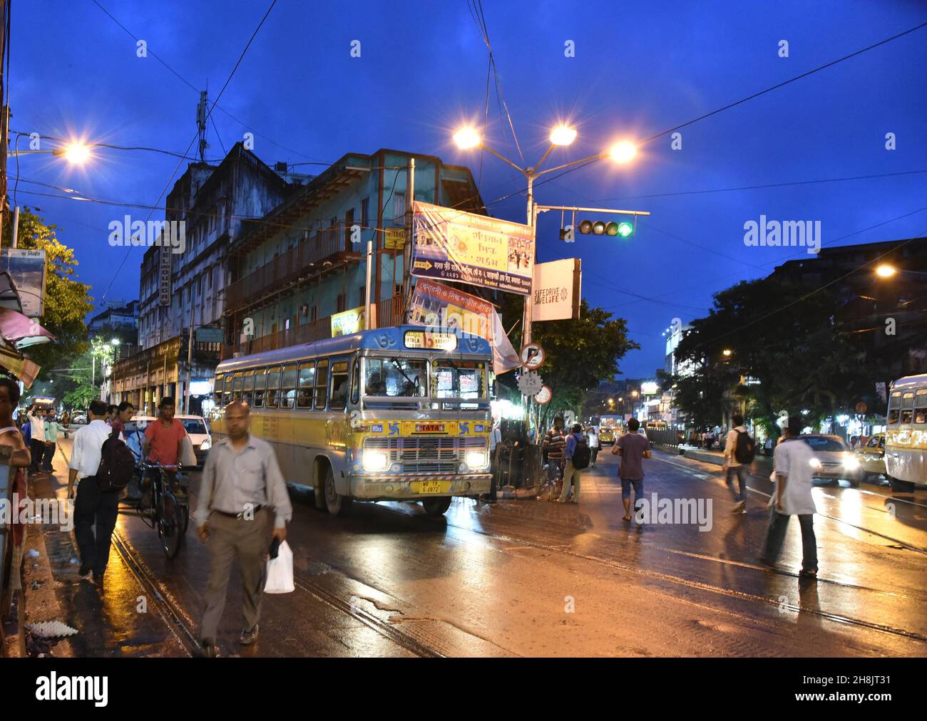 Streets at night in Kolkata. Kolkata (formerly Calcutta) is the capital of India's West Bengal state. Founded as an East India Company trading post, it was India's capital under the British Raj from 1773–1911. Today it’s known for its grand colonial architecture, art galleries and cultural festivals. It’s also home to Mother House, headquarters of the Missionaries of Charity, founded by Mother Teresa, whose tomb is on site. Stock Photo