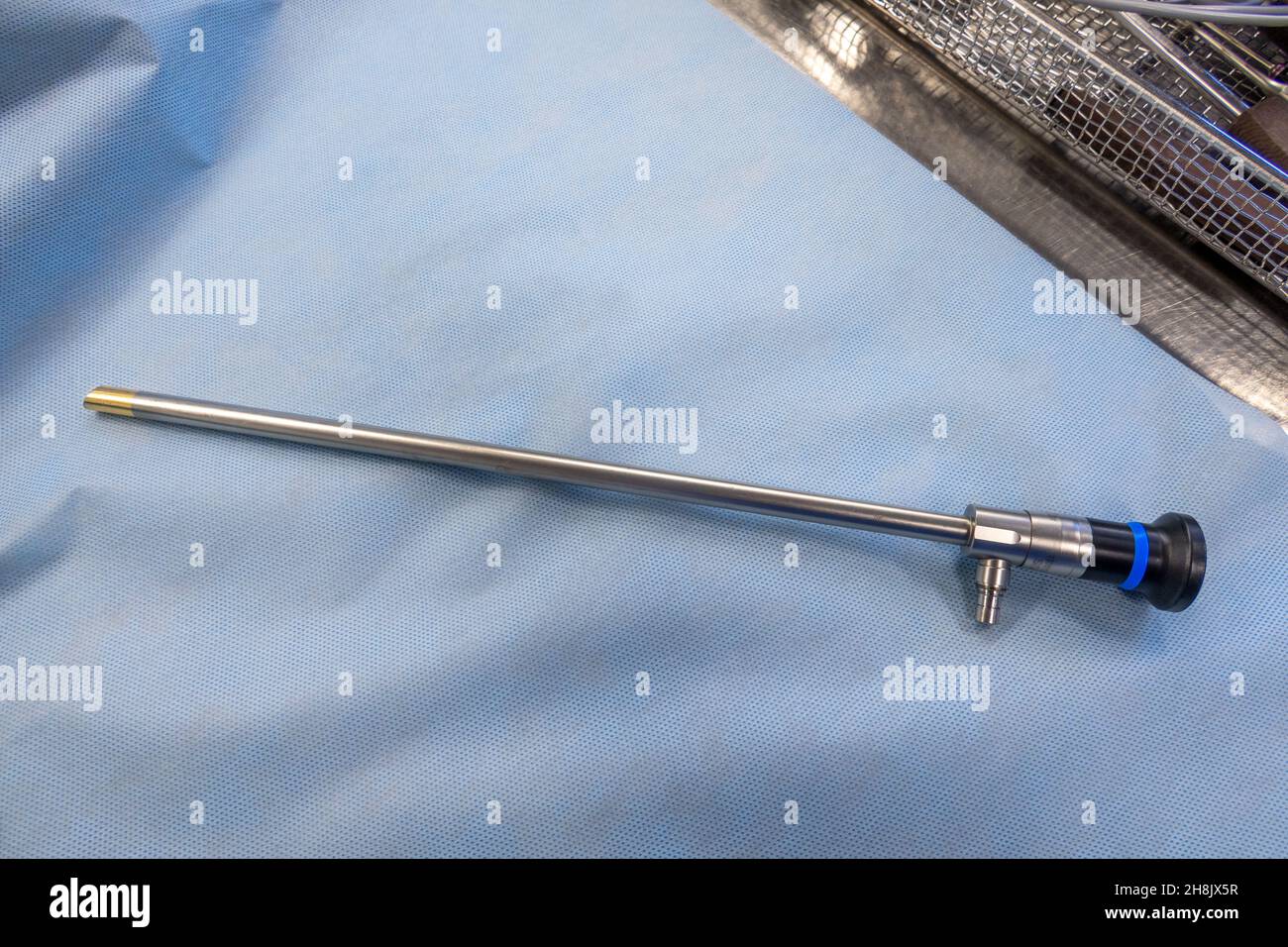 endoscopy optic for performing an abdominal endoscopy lies on a blue