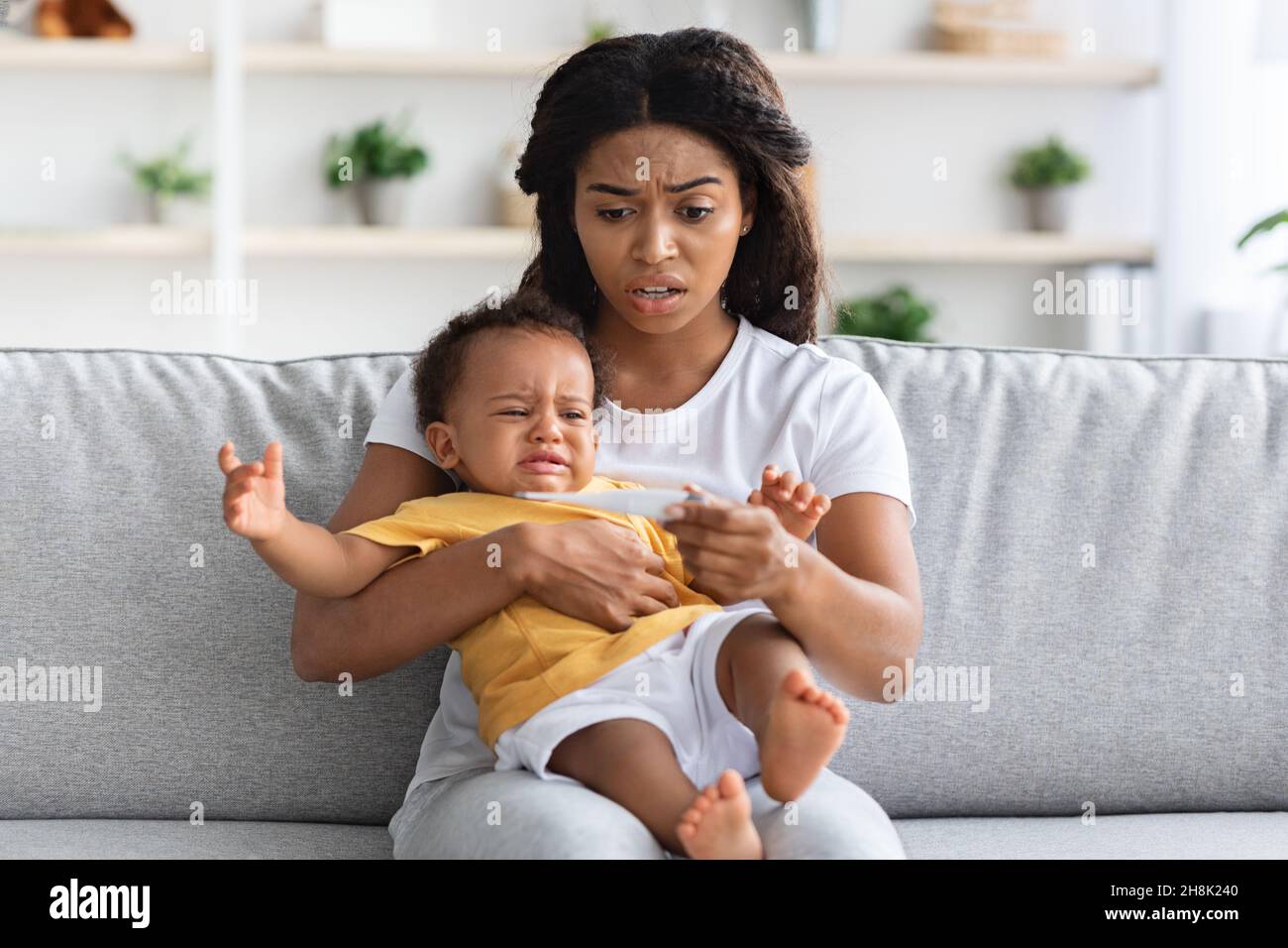 High Fever. Concerned Black Mom Checking Temperature Of Her Crying Infant Baby Stock Photo Alamy
