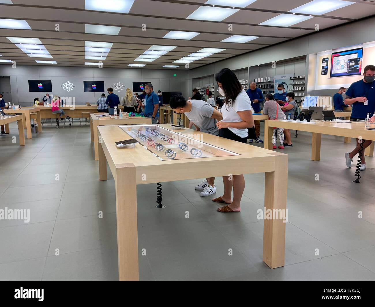 Orlando, FL USA - November 20, 2020: Salespeople and customers at an Apple  store looking at the latest Apple products for sale Stock Photo - Alamy