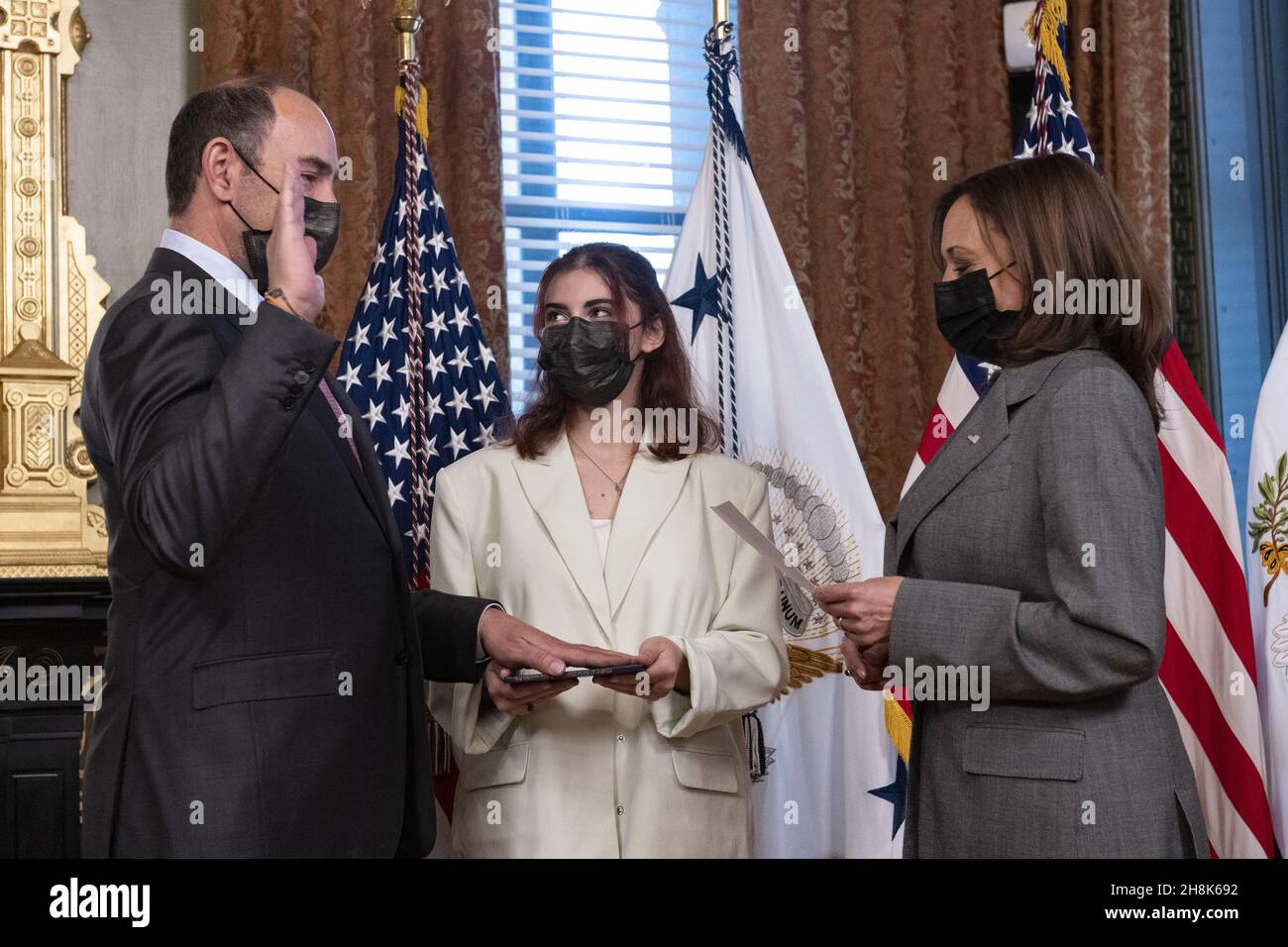 Washington, United States. 30th Nov, 2021. United States Vice President Kamala Harris, right, ceremonially administers the oath of office to Jonathan Eric Kaplan, left, to be Ambassador Extraordinary and Plenipotentiary of the United States of America to the Republic of Singapore in the Vice President's Ceremonial Office in the Eisenhower Executive Office Building in Washington, DC on Tuesday, November 30, 2021. Standing at center holding a copy of the US Constitution is his daughter Samantha. Photo by Ron Sachs/UPI Credit: UPI/Alamy Live News Stock Photo