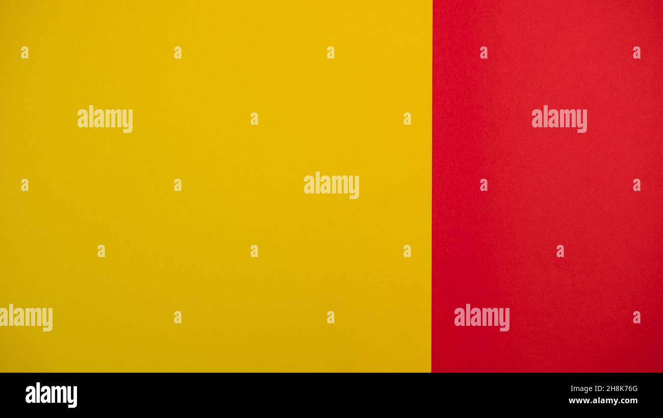 Red and yellow colored background. Colourful paper on top. Template for ...