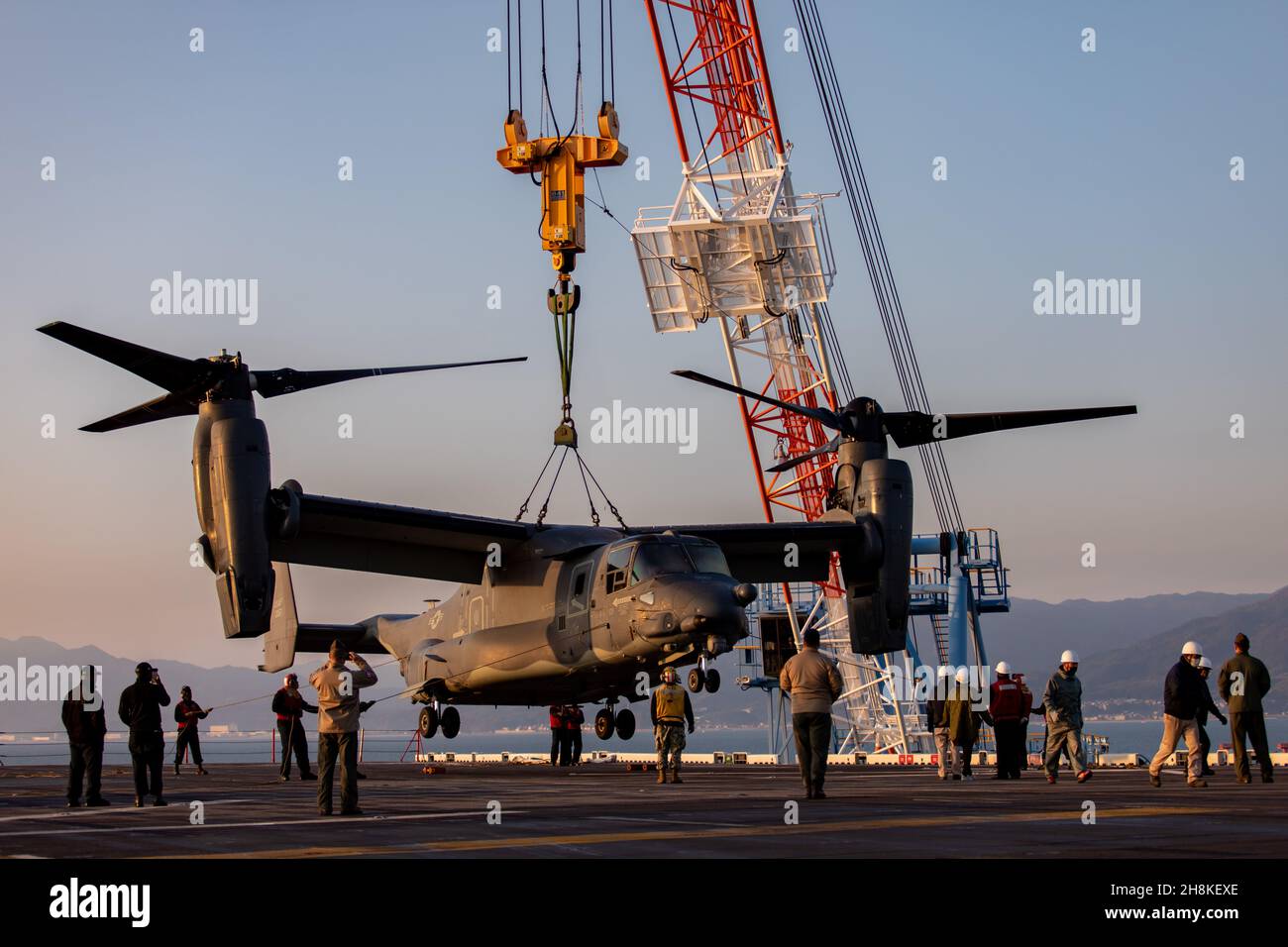U.S. service members crane a CV22 Osprey aircraft for transfer onto Marine Corps Air Station