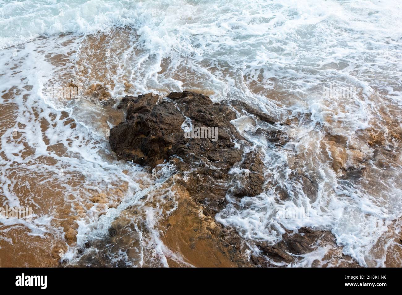 Sea waves from Praia do Rio Vermelho breaking on the clear sands. Salvador, Bahia, Brazil. Stock Photo