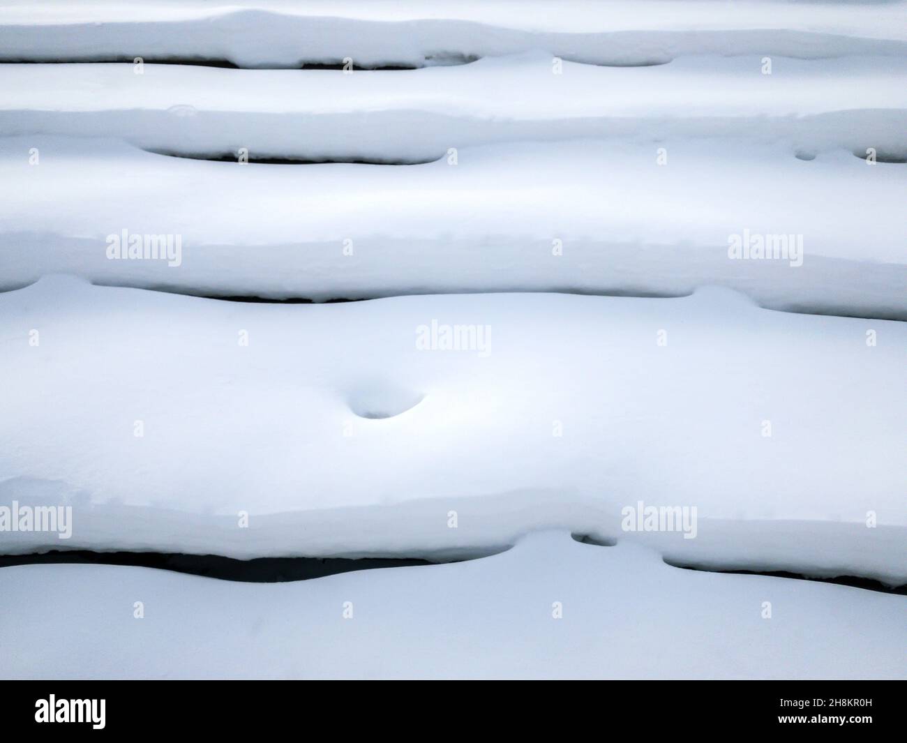 Snow Step steps of staircase covered with thick snow layer. abstract winter ...