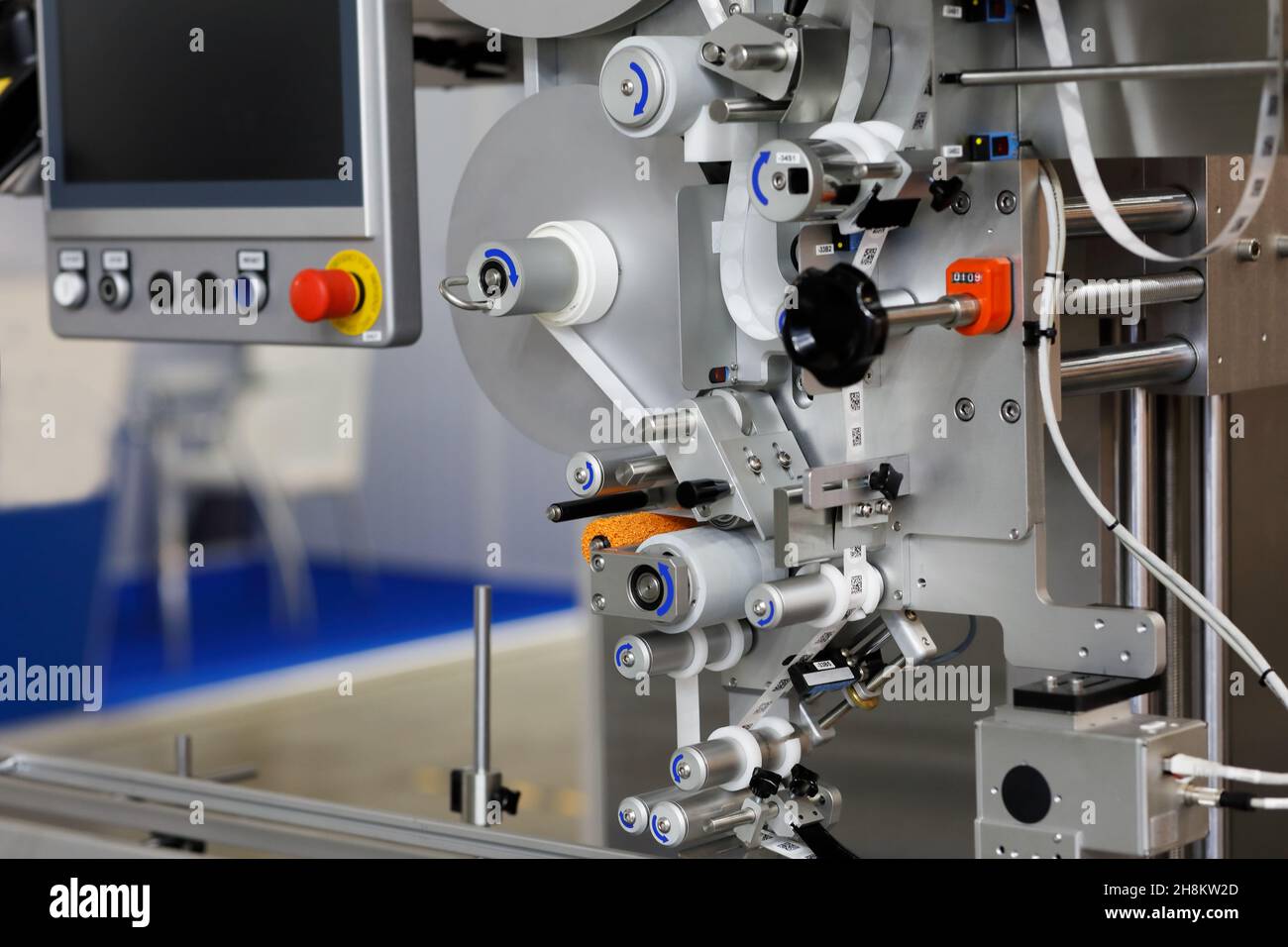 Automatic labeling machine applies stickers with QR code. Selective focus. Stock Photo