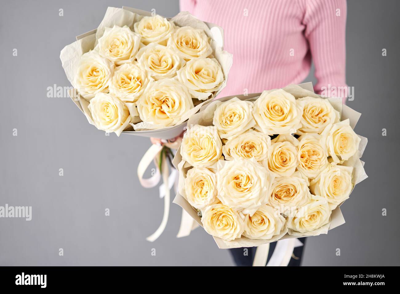 Two beautiful bouquets of peony-shaped white cream roses for mom and daughter Stock Photo