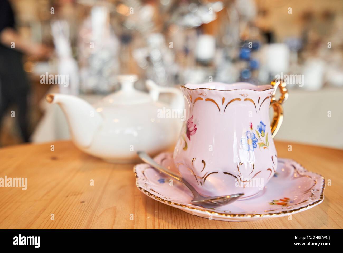 teapot and cup. A magnificent porcelain tea set with a fragrant tea. Green and black tea concept. Side view Stock Photo