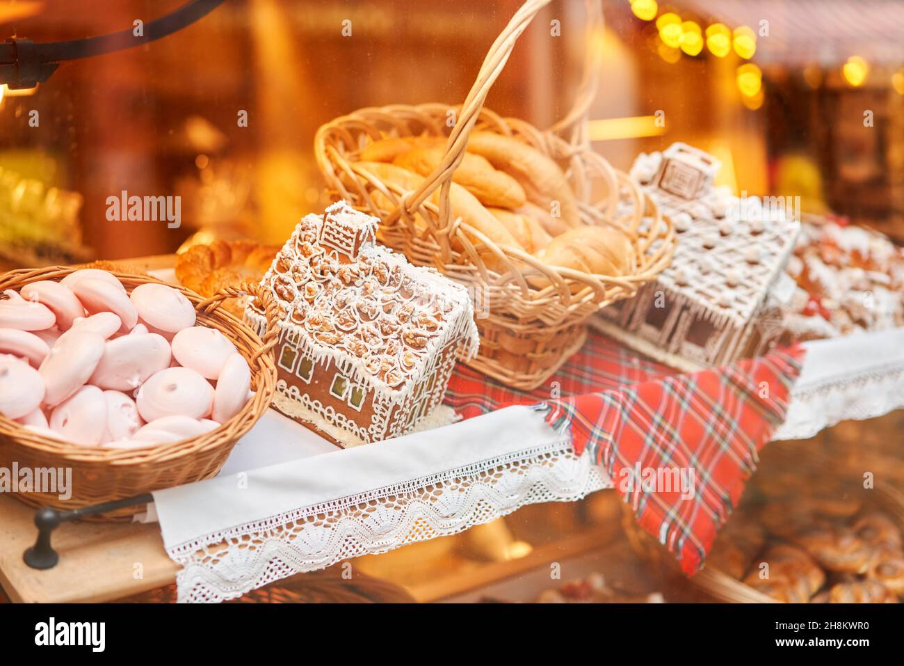 A bakery showcase in a European city for Christmas. Gingerbread house, pretzel, apple crumble, buns. Bread on Christmas and New year. Stock Photo