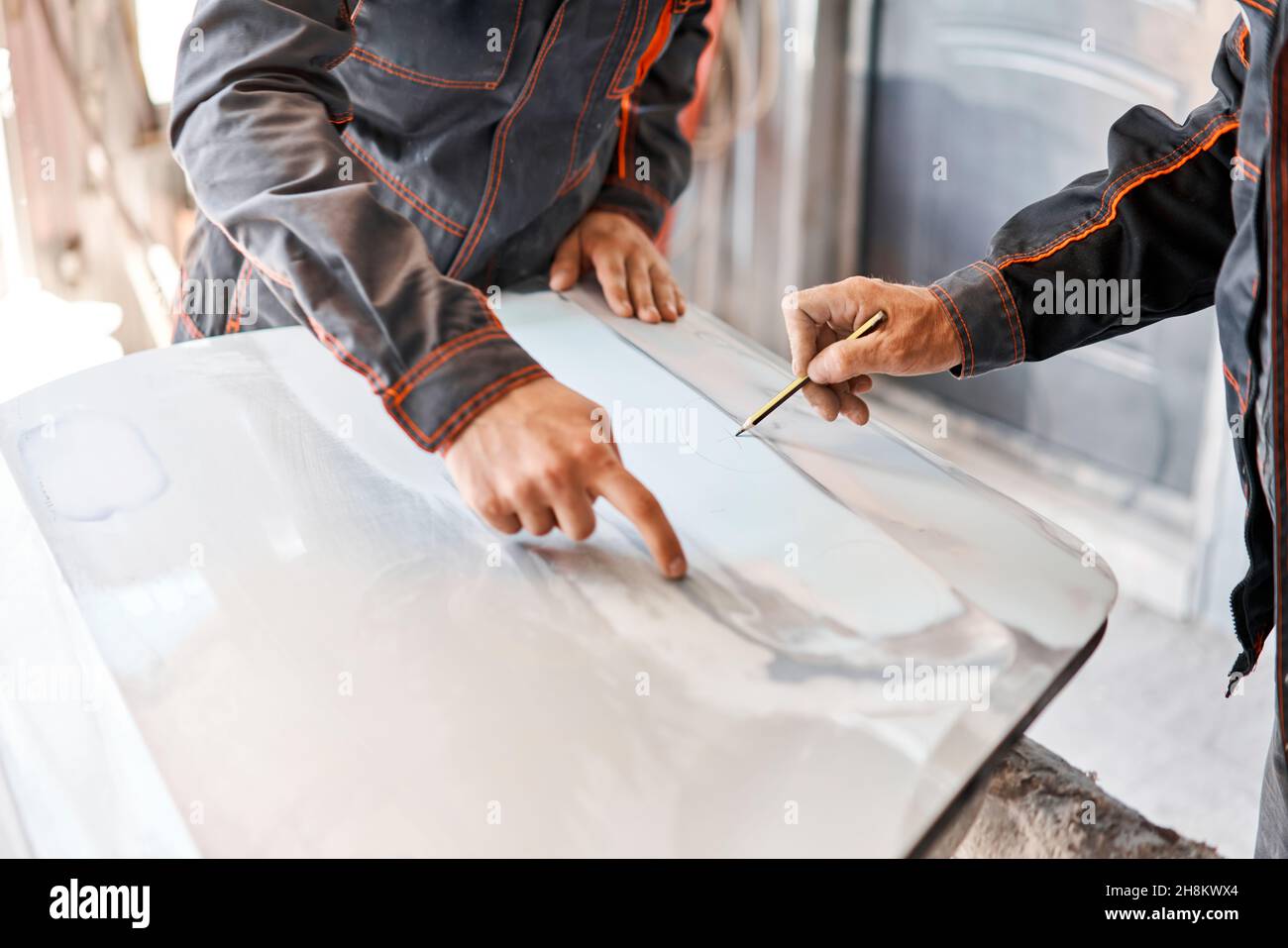 Repairing car body, Application putty close up. The mechanic repair the car. Work after the accident by working sanding primer before painting Stock Photo